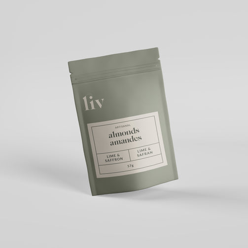 Hand-roasted almonds infused with lime and saffron, packaged in a premium eco-friendly box showcasing bold citrus and delicate spice.